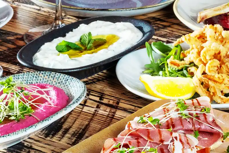 Originating in Spain, tapas are small plates of food served as light snacks during happy hour or as appetizers before the main course.